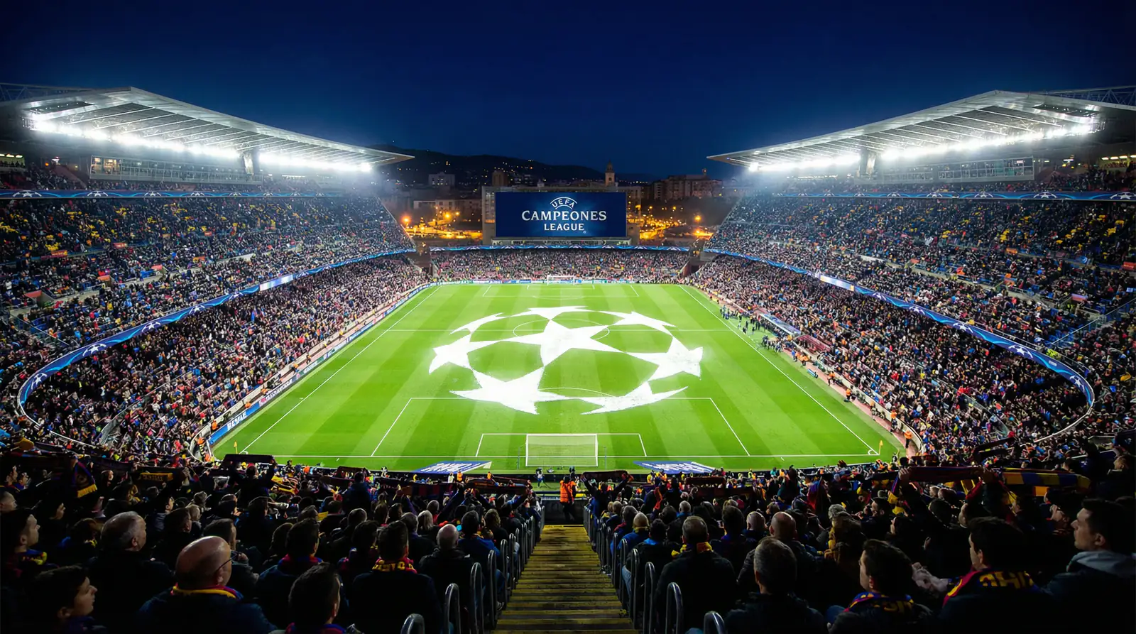 Campo de fútbol iluminado con el logo de la Champions League proyectado sobre el césped